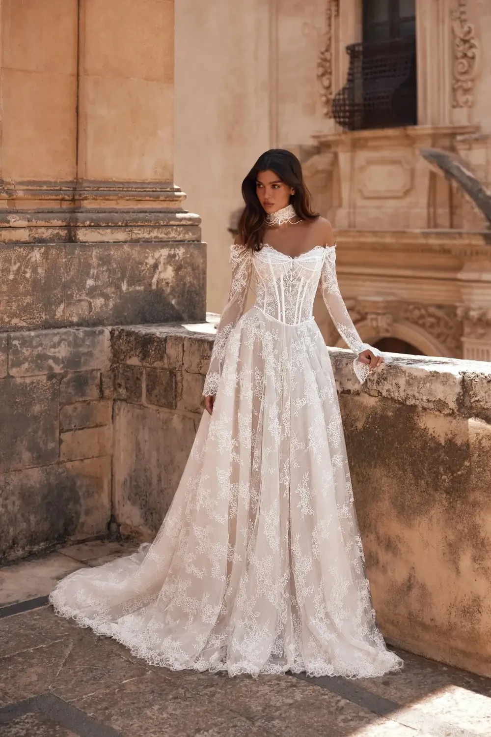 model is wearing an off the shoulder bridal gown