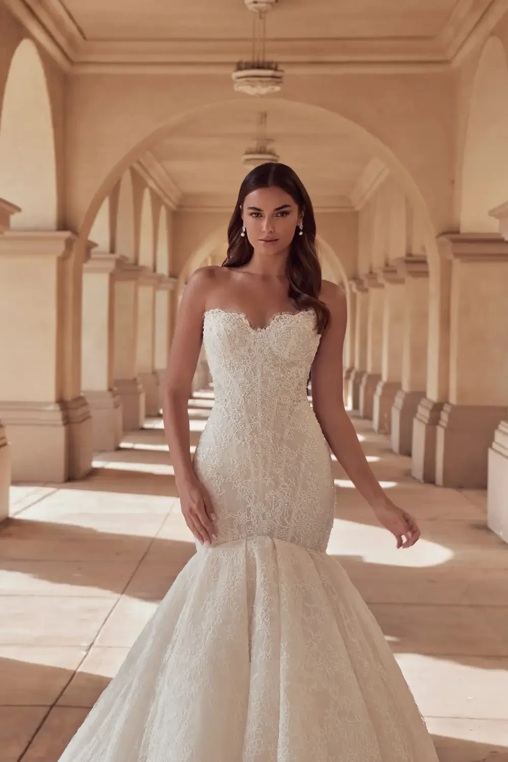 model is wearing a lace bridal gown