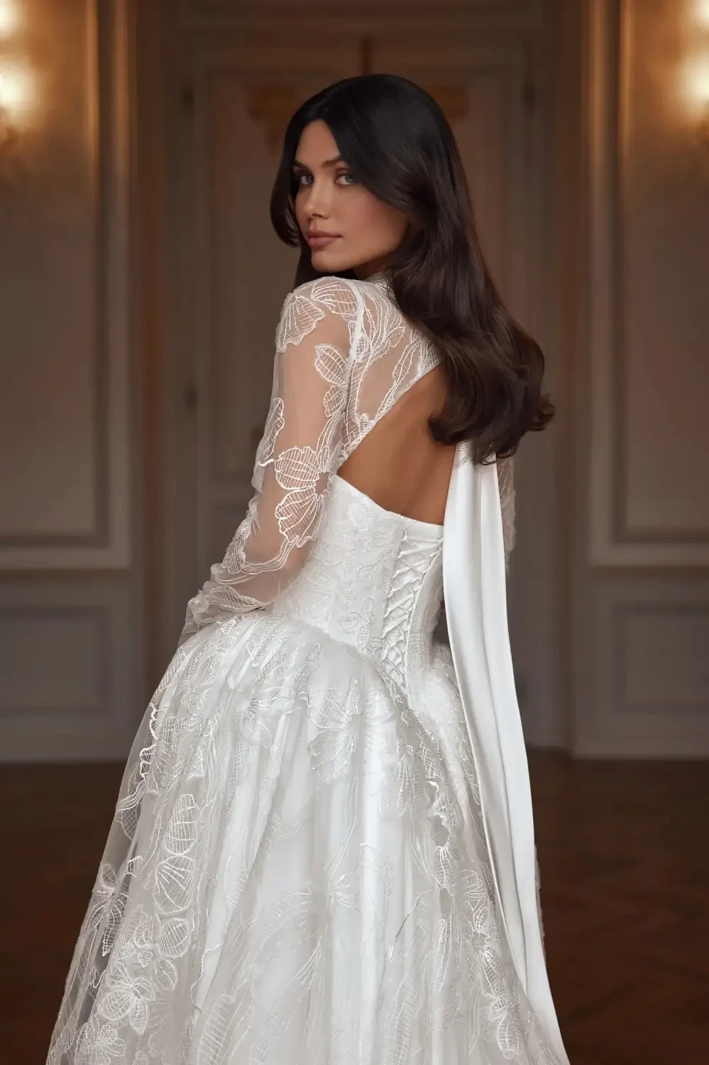 model is wearing a high neck open back bridal gown