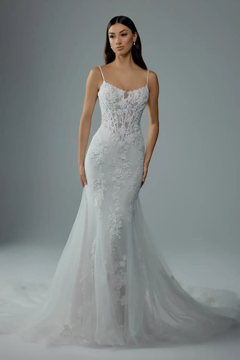 model is wearing an open back sheath bridal gown