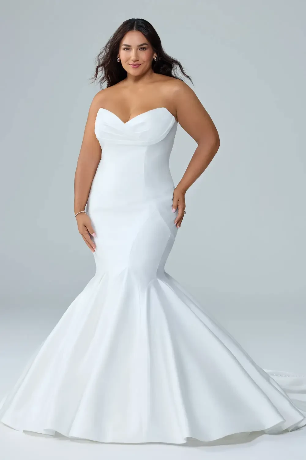 model is wearing a strapless mikado wedding gown